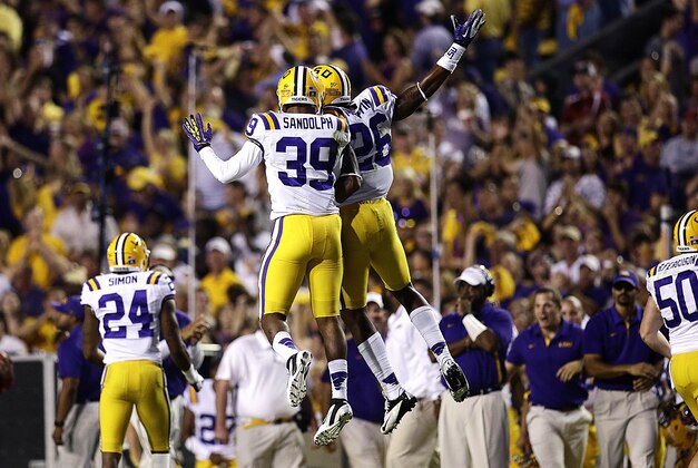 LSU safety Jerqwinick Sandolph (39) celebrates after recovering a fumbled punt with safety Ronald Martin (26) during the first half of their NCAA college football game against Alabama in Baton Rouge, La., Saturday, Nov. 3, 2012. (AP Photo/Bill Haber) LSU safety Jerqwinick Sandolph (39) celebrates after recovering a fumbled punt with safety Ronald Martin (26) during the first half of their NCAA college football game against Alabama in Baton Rouge, La., Saturday, Nov. 3, 2012. (AP Photo/Bill Haber)