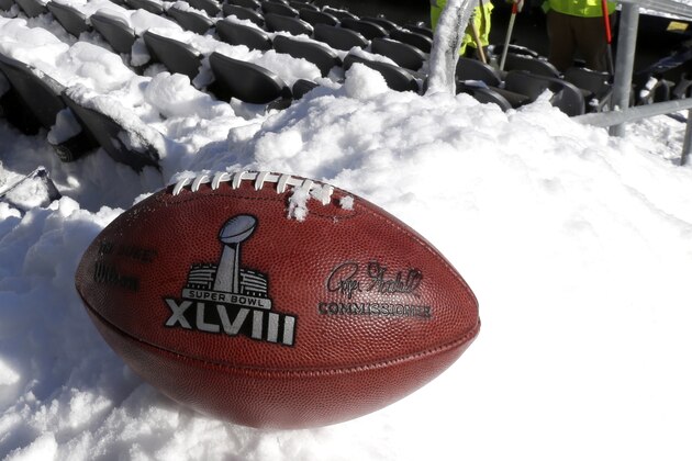 A football with the Super Bowl XLVIII logo is set on a mound of snow as an for an NFL photographer to make photos of it as workers shovel snow off the seating area at MetLife Stadium as crews removed snow ahead of Super Bowl XLVIII following a snow storm, Wednesday, Jan. 22, 2014, in East Rutherford, N.J. Super Bowl XLVIII, which will be played between the Denver Broncos and the Seattle Seahawks on Feb. 2, will be the first NFL title game held outdoors in a city where it snows. (AP Photo/Julio Cortez)