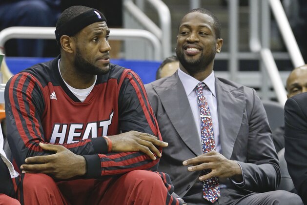 Miami Heat's LeBron James, left, takes a break on the bench with injured Dwyane Wade during the first half of an NBA basketball game in Orlando, Fla., Wednesday, Nov. 20, 2013.(AP Photo/John Raoux) Miami Heat's LeBron James, left, takes a break on the bench with injured Dwyane Wade during the first half of an NBA basketball game in Orlando, Fla., Wednesday, Nov. 20, 2013.(AP Photo/John Raoux)