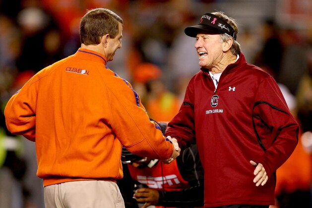 COLUMBIA, SC - NOVEMBER 30:  (L-R) Head coach Dabo Swinney of the Clemson Tigers talks to head coach Steve Spurrier of the South Carolina Gamecocks before their game at Williams-Brice Stadium on November 30, 2013 in Columbia, South Carolina.  (Photo by Streeter Lecka/Getty Images)