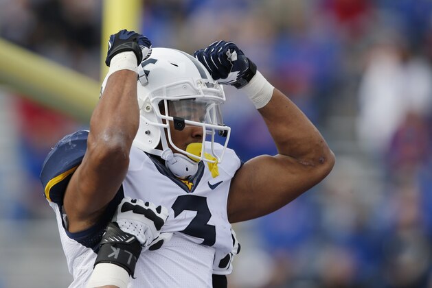 West Virginia running back Charles Sims (3) celebrates a touchdown during the first half of an NCAA college football game against Kansas at Kansas Memorial Stadium in Lawrence, Kan., Saturday, Nov. 16, 2013. (AP Photo/Orlin Wagner)