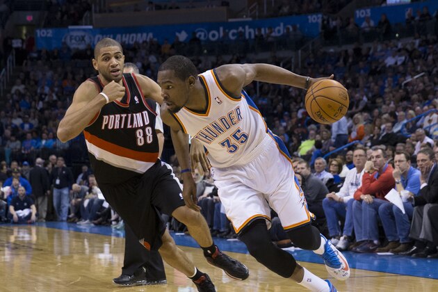 OKLAHOMA CITY, OK - January 21, 2014 : Kevin Durant #35 of the Oklahoma City Thunder handling the ball during a game against the Portland Trail Blazers at the Chesapeake Arena on January 21, 2014 in Oklahoma City, Oklahoma. NOTE TO USER:  User expressly acknowledges and agrees that, by downloading and/or using this photograph, user is consenting to the terms and conditions of the Getty Images License Agreement. Mandatory Copyright Notice:  Copyright 2014 NBAE (Photo by Richard Rowe/NBAE via Getty Images)