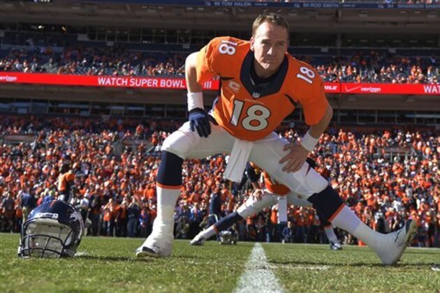 ADVANCE FOR WEEKEND EDITIONS, JAN. 25-26 - In this Jan. 19, 2014, file photo, Denver Broncos quarterback Peyton Manning loosens up before the AFC Championship NFL playoff football game against New England Patriots in Denver. When he faces the Seattle Seahawks next Sunday, Manning can become the first starting quarterback to win the Super Bowl with two franchises. (AP Photo/Jack Dempsey, File)