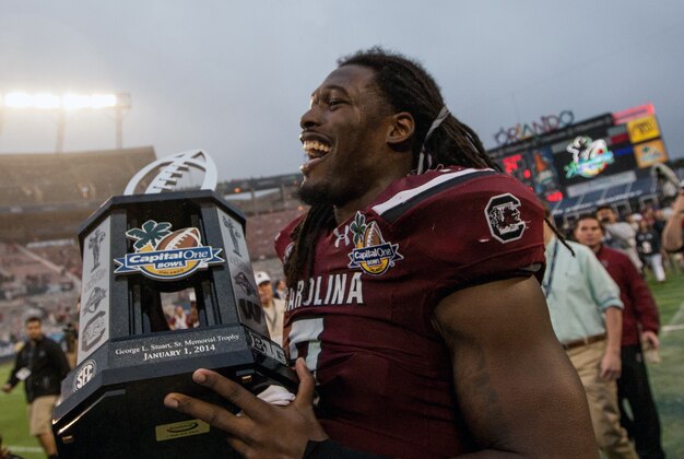 Jan 1, 2014; Orlando, FL, USA; South Carolina Gamecocks defensive end Jadeveon Clowney (7) holds the Capital One Bowl trophy after defeating the Wisconsin Badgers at the game held at the Florida Citrus Bowl. Mandatory Credit: Rob Foldy-USA TODAY Sports