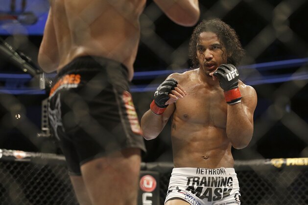 Benson Henderson, right, fights Gilbert Melendez in a UFC lightweight championship mixed martial arts fight in San Jose, Calif., Saturday, April 20, 2013. Henderson won by split decision to retain the championship. (AP Photo/Jeff Chiu) Benson Henderson, right, fights Gilbert Melendez in a UFC lightweight championship mixed martial arts fight in San Jose, Calif., Saturday, April 20, 2013. Henderson won by split decision to retain the championship. (AP Photo/Jeff Chiu)