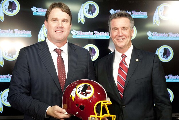 Jan 9, 2014; Ashburn, VA, USA; Washington Redskins head coach Jay Gruden and general manager Bruce Allen pose for a photo after a press conferences at Redskins Park Team Auditorium. Mandatory Credit: Brad Mills-USA TODAY Sports