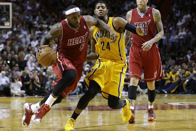 Miami Heat's LeBron James (6) drives to the basket past Indiana Pacers' Paul George (24) during the second half of an NBA basketball game, Wednesday, Dec. 18, 2013, in Miami. The Heat defeated the Pacers 97-94. (AP Photo/Lynne Sladky)