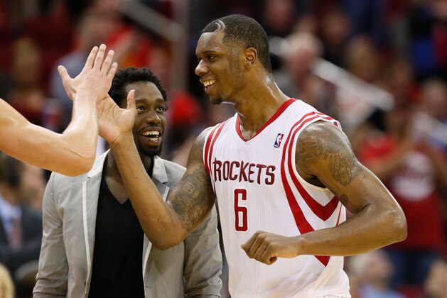 Jan 18, 2014; Houston, TX, USA; Houston Rockets forward Terrence Jones (6) celebrates a score with teammate Patrick Beverley (suit) during the second half against the Milwaukee Bucks at Toyota Center. The Rockets won 114-104. Mandatory Credit: Soobum Im-USA TODAY Sports
