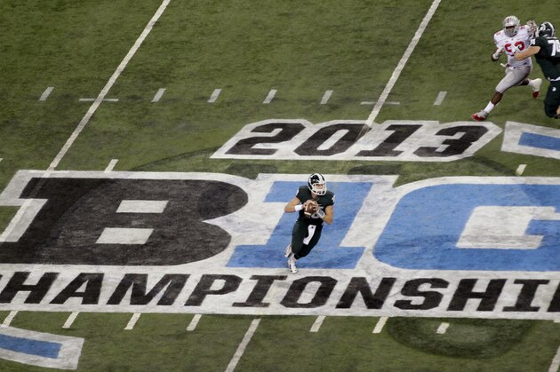 Michigan State quarterback Connor Cook (18) looks to pass against Ohio State during the first half of a Big Ten Conference championship NCAA college football game Saturday, Dec. 7, 2013, in Indianapolis. (AP Photo/AJ Mast)
