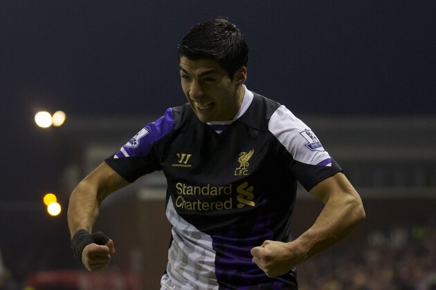 Liverpool's Luis Suarez celebrates after scoring his first goal against Stoke during their English Premier League soccer match at the Britannia Stadium, Stoke, England, Sunday Jan 12, 2014. (AP Photo/Jon Super)