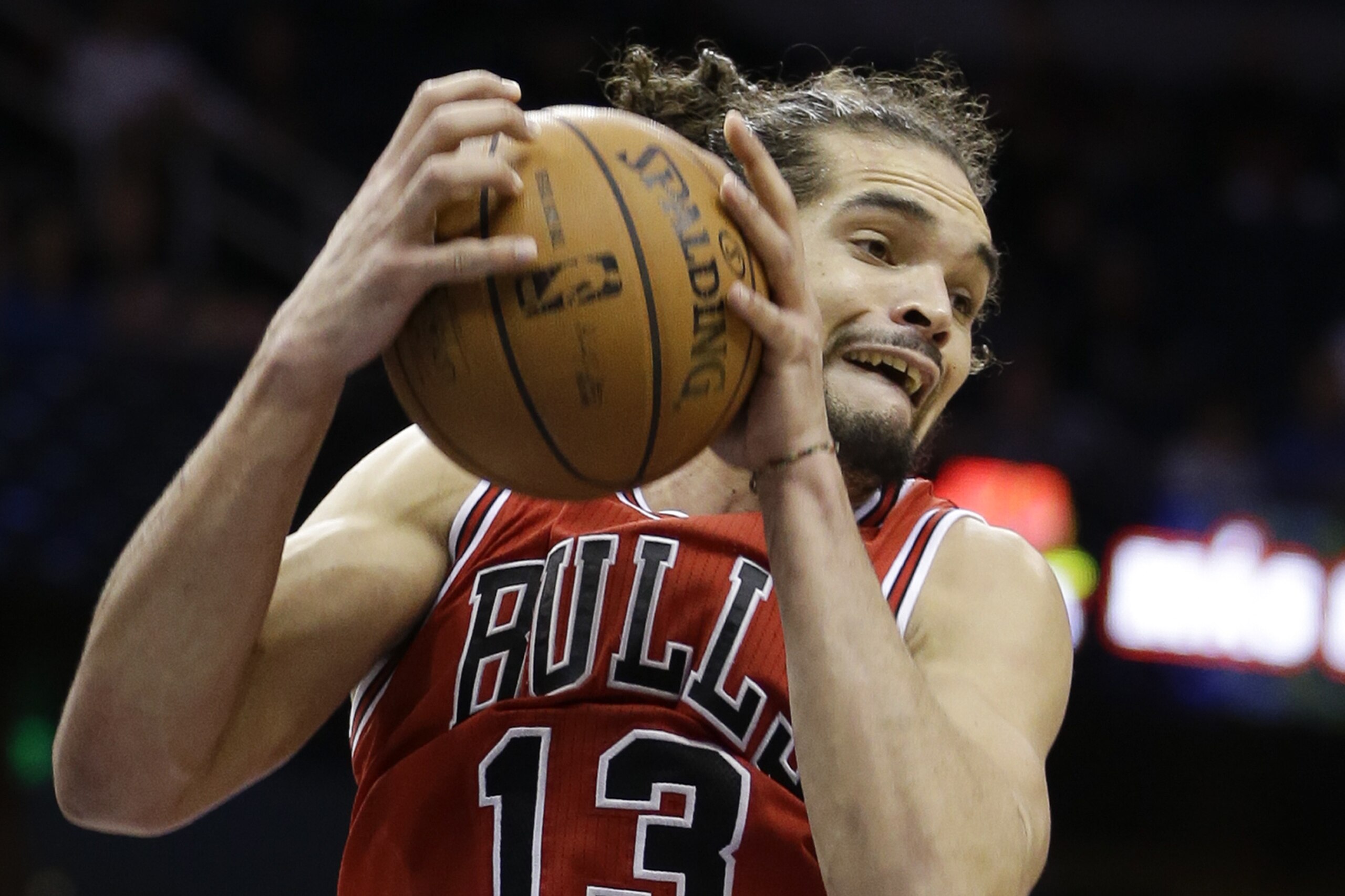 Chicago Bulls' Joakim Noah (13) grabs a rebound against the Orlando Magic during the second half of an NBA basketball game in Orlando, Fla., Wednesday, Jan. 15, 2014. Chicago won the game in triple overtime 128-125.(AP Photo/John Raoux)
