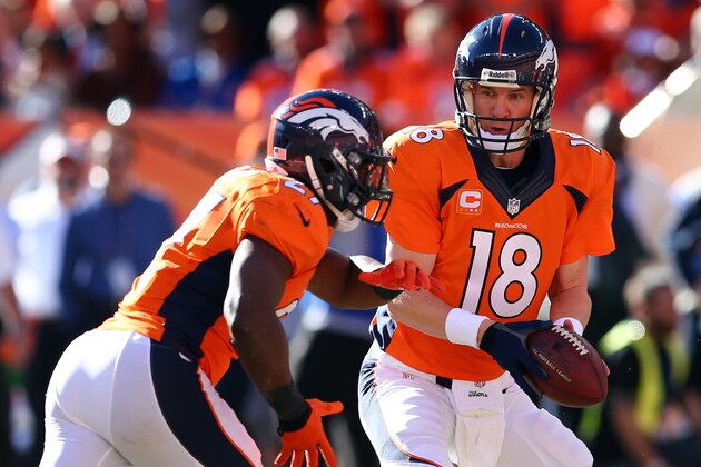 DENVER, CO - JANUARY 19:   Peyton Manning #18 of the Denver Broncos hands the ball off to Knowshon Moreno #27 during the AFC Championship game at Sports Authority Field at Mile High on January 19, 2014 in Denver, Colorado.  (Photo by Elsa/Getty Images)