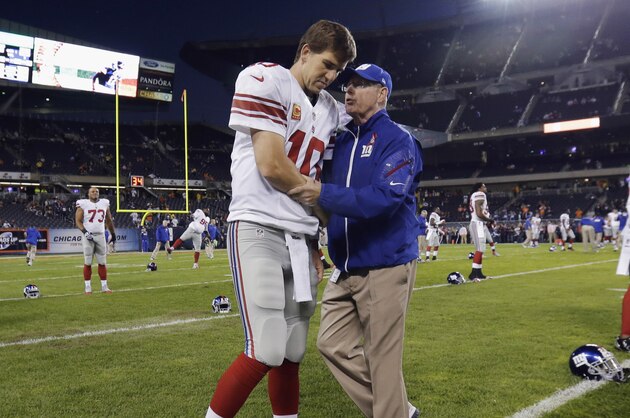 New York Giants coach Tom Coughlin talks to quarterback Eli Manning before the Giants' NFL football game against the Chicago Bears, Thursday, Oct. 10, 2013, in Chicago. (AP Photo/Nam Y. Huh)