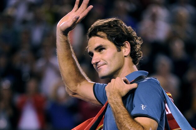 Roger Federer of  Switzerland walks off the Rod Laver Arena after his semifinal loss to Rafael Nadal of Spain during their semifinal at the Australian Open tennis championship in Melbourne, Australia, Friday, Jan. 24, 2014.(AP Photo/Andrew Brownbill)