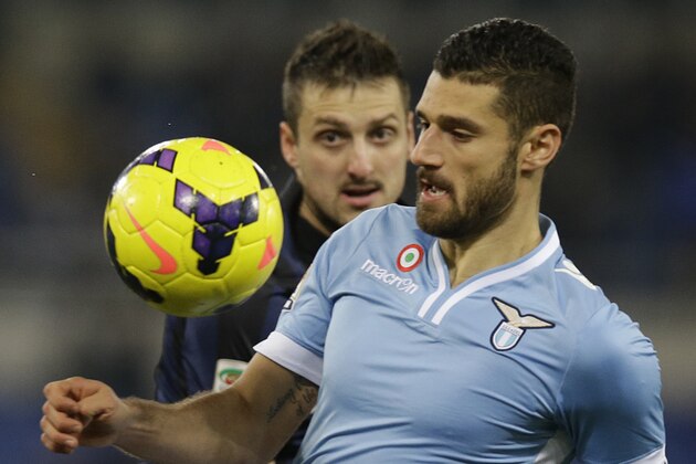Lazio's Andrea Candreva and Inter of Milan's Zdravko Kuzmanovic fight for the ball during an Italian Serie A soccer match in Rome's Olympic stadium, Monday, Jan. 6, 2014. (AP Photo/Gregorio Borgia)