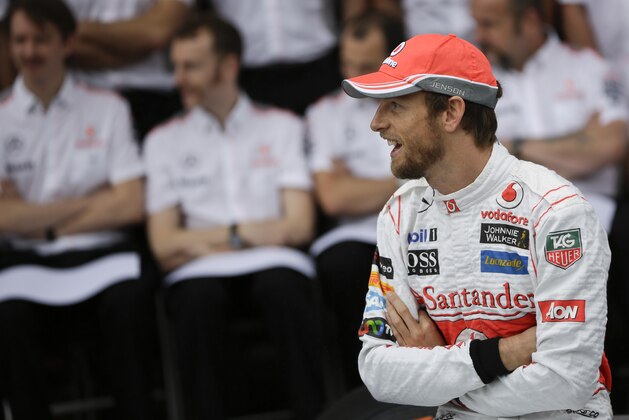 McLaren Mercedes driver Jenson Button, of Britain, smiles before an official team photo at the Interlagos race track in Sao Paulo, Brazil, Saturday, Nov. 23, 2013. The Brazilian Formula One Grand Prix will take place on Sunday. (AP Photo/Felipe Dana)