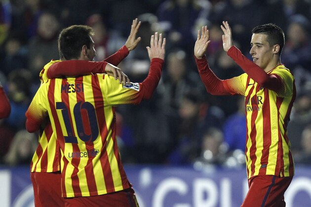 Barcelona's  Cristian Tello, right, is congratulated by teammate Lionel Messi from Argentina after scoring a goal against  Levante during their la Copa del Rey soccer match at the Ciutat de Valencia stadium in Valencia, Spain, Wednesday Jan. 22, 2014. (AP Photo/Alberto Saiz)