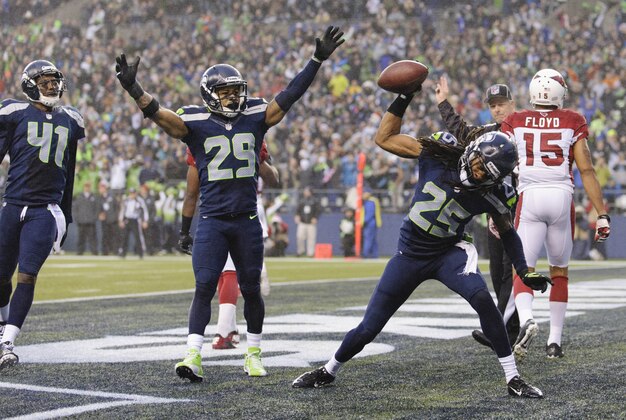 Dec 22, 2013; Seattle, WA, USA; Seattle Seahawks cornerback Richard Sherman (25) and Seattle Seahawks free safety Earl Thomas (29) celebrate after Sherman intercepted a pass thrown by Arizona Cardinals quarterback Carson Palmer (3) (not pictured) during the second half at CenturyLink Field. Arizona defeated Seattle 17-10. Mandatory Credit: Steven Bisig-USA TODAY Sports