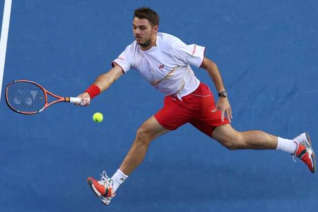 Stanislas Wawrinka of Switzerland reaches for a shot to Tomas Berdych of the Czech Republic during their semifinal at the Australian Open tennis championship in Melbourne, Australia, Thursday, Jan. 23, 2014.(AP Photo/Eugene Hoshiko)