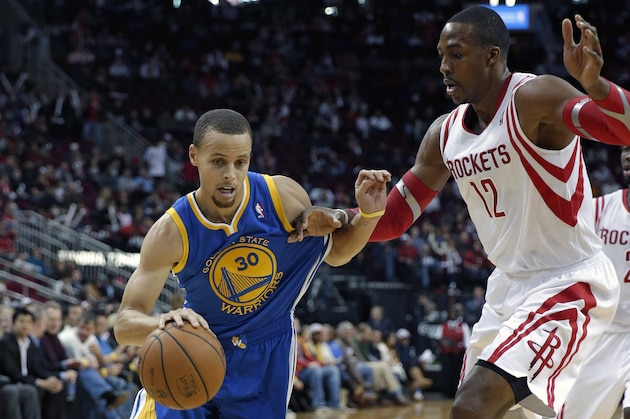 Golden State Warriors' Stephen Curry (30) drives around Houston Rockets' Dwight Howard (12) during the first quarter of an NBA basketball game Friday, Dec. 6, 2013, in Houston. (AP Photo/David J. Phillip)