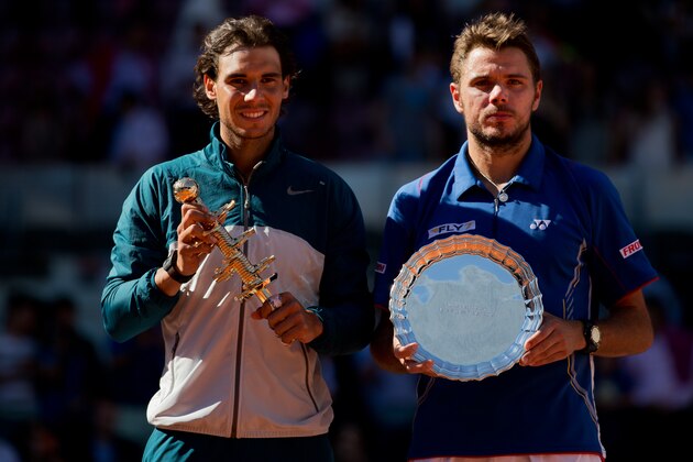 MADRID, SPAIN - MAY 12:  Rafael Nadal (L) of Spain stands with runner up Stanislas Wawrinka of Switzerland holding their trophies after Nadal won the final on day nine of the Mutua Madrid Open tennis tournament at the Caja Magica  on May 12, 2013 in Madrid, Spain.  (Photo by Gonzalo Arroyo Moreno/Getty Images)