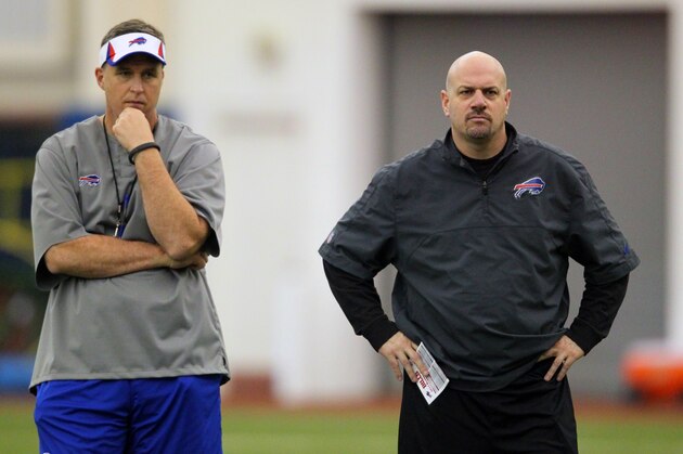 Buffalo Bills' head coach Doug Marrone, left, and defensive coordinator Mike Pettine, right, watch the rookie minicamp at the team's NFL football training facility in Orchard Park, N.Y., Friday, May 10, 2013. (AP Photo/Bill Wippert)
