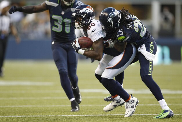 Aug 17, 2013; Seattle, WA, USA; Denver Broncos wide receiver Demaryius Thomas (88) is tackled by Seattle Seahawks cornerback Richard Sherman (25) after making a reception during the second quarter at CenturyLink Field. Mandatory Credit: Joe Nicholson-USA TODAY Sports