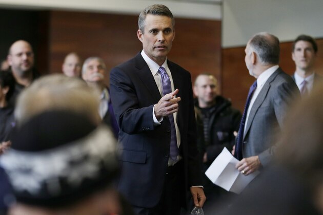 Chris Petersen arrives to be introduced as the new head football coach at the University of Washington, Monday, Dec. 9, 2013, in Seattle. Petersen formerly was head coach at Boise State. (AP Photo/Ted S. Warren)