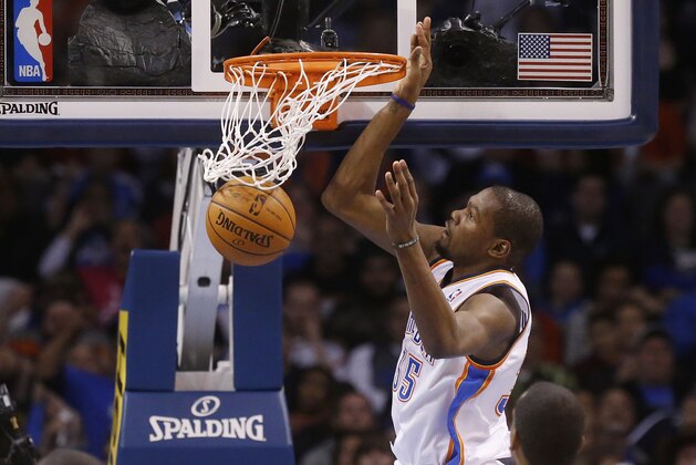 Oklahoma City Thunder forward Kevin Durant (35) dunks against the Milwaukee Bucks in the second quarter of an NBA basketball game in Oklahoma City, Saturday, Jan. 11, 2014. (AP Photo/Sue Ogrocki)