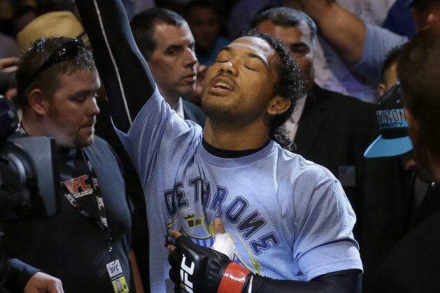 Benson Henderson walks to the ring before fighting Gilbert Melendez in a UFC lightweight championship mixed martial arts fight in San Jose, Calif., Saturday, April 20, 2013. Henderson won by split decision to retain the championship. (AP Photo/Jeff Chiu)