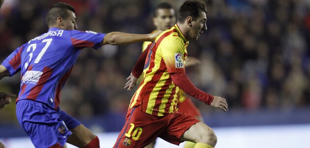Barcelona's Lionel Messi from Argentina drives the ball with Levante's Camarasa during their la Copa del Rey soccer match at the Ciutat de Valencia stadium in Valencia, Spain, Wednesday Jan. 22, 2014. (AP Photo/Alberto Saiz)