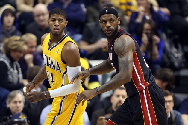 Dec 10, 2013; Indianapolis, IN, USA; Indiana Pacers forward Paul George (24) is guarded by Miami Heat forward LeBron James (6) at Bankers Life Fieldhouse. Mandatory Credit: Brian Spurlock-USA TODAY Sports