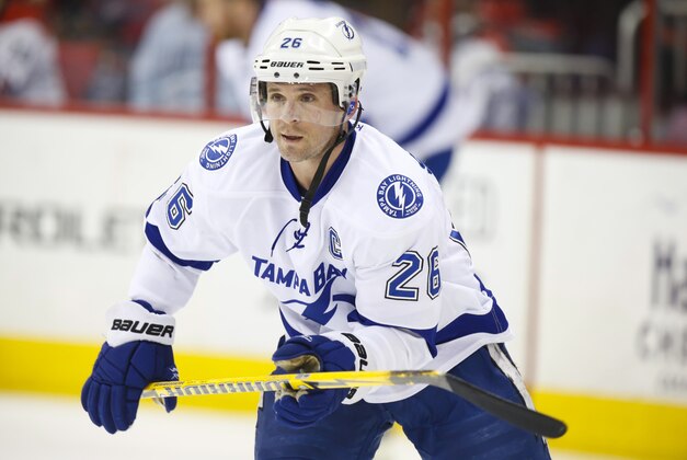 Jan 19, 2014; Raleigh, NC, USA; Tampa Bay Lightning forward Martin St. Louis (26) looks on before the game against the Carolina Hurricanes at PNC Arena. The Tampa Bay Lightning defeated the Carolina Hurricanes 5-3. Mandatory Credit: James Guillory-USA TODAY Sports