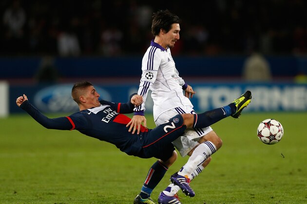 PARIS, FRANCE - NOVEMBER 05:  Marco Verratti of PSG (L) tackles Sacha Kljestan of Anderlect during the UEFA Champions League Group C match between Paris Saint Germain and RSC Anderlecht at Parc des Princes on November 5, 2013 in Paris, France.  (Photo by Harry Engels/Getty Images)