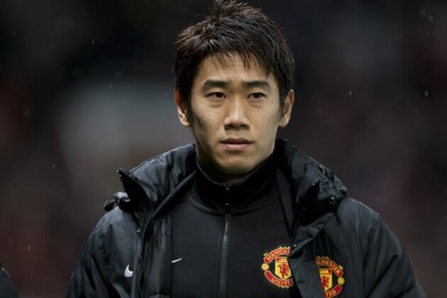 FILE - In this Wednesday Jan. 1, 2014 file photo, Manchester United's Shinji Kagawa heads for the substitutes bench before his team's English Premier League soccer match against Tottenham at Old Trafford Stadium, Manchester, England. Kagawa has started just seven of Manchester United’s 21 league games so far this season, a struggle that has been well-documented in both Europe and Asia, but the playmaker is almost certain to be in the starting lineup for Japan in its opening World Cup match against Ivory Coast on June 14. (AP Photo/Jon Super)
