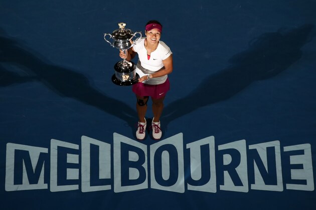 Li Na of China holds the championship trophy after defeating Dominika Cibulkova of Slovakia in their women's singles final at the Australian Open tennis championship in Melbourne, Australia, Saturday, Jan. 25, 2014.(AP Photo/Eugene Hoshiko)