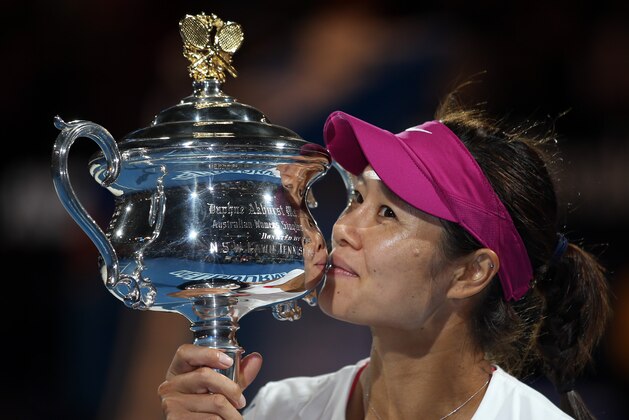 Li Na of China kisses the championship trophy after defeating Dominika Cibulkova of Slovakia in their women's singles final at the Australian Open tennis championship in Melbourne, Australia, Saturday, Jan. 25, 2014. (AP Photo/Rick Rycroft)