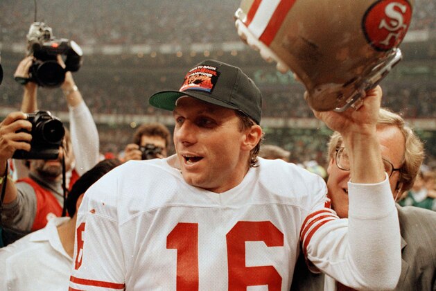 San Francisco 49ers quarterback Joe Montana raises his helmet toward the crowd as he leaves the field following the team's 55-10 victory over the Denver Broncos in the Super Bowl in New Orleans, La., Jan. 28, 1990.   (AP Photo/Lennox McLennon)
