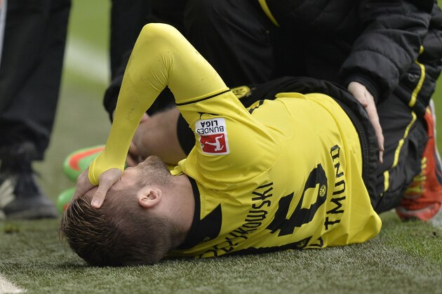 Dortmund's Jakub Blaszczykowski of Poland is injured on the ground and has to leaves the stadium during the German Bundesliga soccer match between Borussia Dortmund and FC Augsburg in Dortmund,  Germany, Saturday, Jan. 25, 2014. (AP Photo/Martin Meissner)