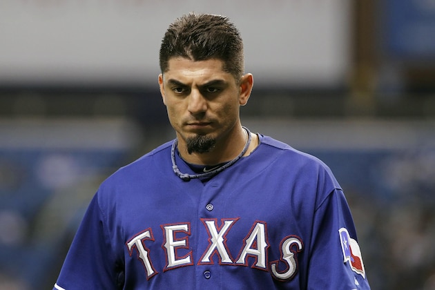 Sep 16, 2013; St. Petersburg, FL, USA; Texas Rangers starting pitcher Matt Garza (22) walks back to the dugout after he pitched the first inning against the Tampa Bay Rays at Tropicana Field. Mandatory Credit: Kim Klement-USA TODAY Sports