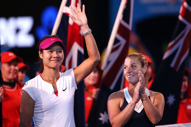MELBOURNE, AUSTRALIA - JANUARY 25: Na Li (L) of China and Dominika Cibulkova of Slovakia watch the presentation after their women's final match during day 13 of the 2014 Australian Open at Melbourne Park on January 25, 2014 in Melbourne, Australia.  (Photo by Clive Brunskill/Getty Images)
