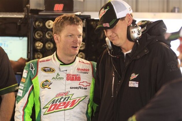 Dale Earnhardt Jr., talks to crew chief Steve Letarte, right, during his first practice since recovering from concussions at Martinsville Speedway  in Martinsville, Va., Friday, Oct. 26, 2012.  (AP Photo/Steve Helber)