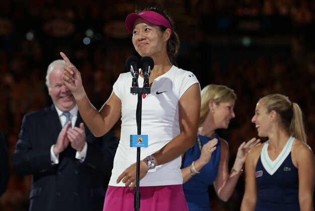 Li Na of China speaks after defeating Dominika Cibulkova of Slovakia, right,  in their women's singles final at the Australian Open tennis championship in Melbourne, Australia, Saturday, Jan. 25, 2014. (AP Photo/Aaron Favila)