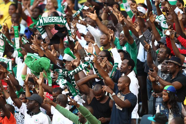 CAPE TOWN, SOUTH AFRICA - JANUARY 19:  Nigerian fans celebrate their second goal during the 2014 African Nations Championship match between South Africa and Nigeria at Cape Town Stadium on January 19, 2014 in Cape Town, South Africa. (Photo by Shaun Roy/Gallo Images/Getty Images)