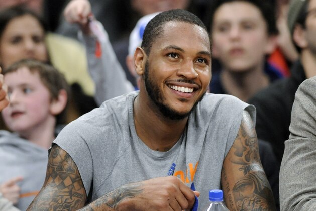 New York Knicks' Carmelo Anthony smiles as he watches from the bench during the fourth quarter of an NBA basketball game against the Charlotte Bobcats Friday, Jan. 24, 2014, at Madison Square Garden in New York. Anthony scored 62 points as the Knicks won 125-96. (AP Photo/Bill Kostroun)
