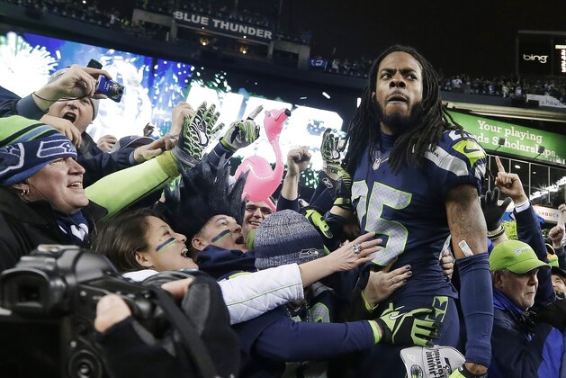 ADVANCE FOR WEEKEND EDITIONS, JAN. 25-26 - In this Jan. 19, 2013, file photo, Seattle Seahawks' Richard Sherman celebrates with fans after after the  NFC championship NFL football game against the San Francisco 49ers in Seattle. The last time one of Seattle's major franchises had a parade to celebrate a title, no one on the Seahawks roster was born. To call Seattle's championship history thin is an understatement. Maybe that's why there's so much support behind these Super Bowl-bound Seahawks. (AP Photo/Elaine Thompson, File)