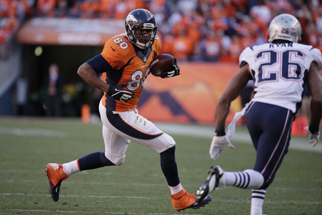 Denver Broncos tight end Julius Thomas (80) runs toward Denver Broncos free safety Rahim Moore (26) during the second half of the AFC Championship NFL playoff football game in Denver, Sunday, Jan. 19, 2014. (AP Photo/Charlie Riedel)