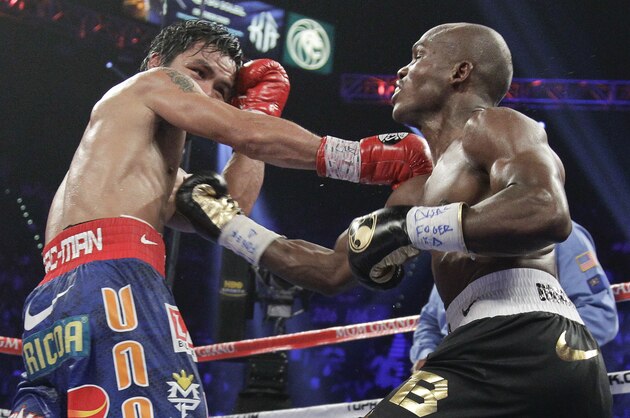 Manny Pacquiao, left, and Timothy Bradley exchange punches in the 12th round of their WBO world welterweight title fight Saturday, June 9, 2012, in Las Vegas. Bradley won by split decision. (AP Photo/Julie Jacobson)