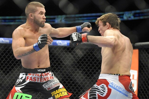 Jan 25, 2014; Chicago, IL, USA; Darren Elkins (red gloves) fights Jeremy Stephens (blue gloves) during UFC on FOX 10 at the United Center. Mandatory Credit: David Banks-USA TODAY Sports