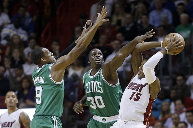 Miami Heat point guard Mario Chalmers (15) prepares to pass as Boston Celtics power forward Brandon Bass (30) and point guard Rajon Rondo (9) defend during the fourth quarter of an NBA basketball game in Miami, Tuesday, Jan. 21, 2014. The Heat won 93-86. (AP Photo/Alan Diaz) Miami Heat point guard Mario Chalmers (15) prepares to pass as Boston Celtics power forward Brandon Bass (30) and point guard Rajon Rondo (9) defend during the fourth quarter of an NBA basketball game in Miami, Tuesday, Jan. 21, 2014. The Heat won 93-86. (AP Photo/Alan Diaz)
